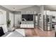 Open living room featuring gray walls and tile flooring connecting the kitchen and dining area at 3296 S Bryant St, Englewood, CO 80110