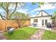 Private backyard features a well-manicured lawn, stone walkway, patio set, and is bordered by a wooden fence at 3289 Perry St, Denver, CO 80212