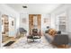 Bright living room features exposed brick fireplace, hardwood floors, and an open floorplan at 3289 Perry St, Denver, CO 80212