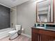 Bathroom featuring tub, shower, dark tiling, and wood vanity at 891 14Th St # 3410, Denver, CO 80202