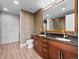 Modern bathroom featuring double vanity, wood cabinets, and large mirror at 891 14Th St # 3410, Denver, CO 80202
