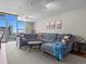 Cozy living room with large sectional sofa, carpet flooring, and cityscape view at 891 14Th St # 3410, Denver, CO 80202