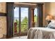 Main bedroom with mountain views and access to a private balcony at 83 Castle Pines N Dr, Castle Rock, CO 80108