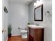 Charming powder room with vanity, hardwood floors, and decor at 9403 Southern Hills Cir, Lone Tree, CO 80124