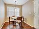 Bright dining area featuring hardwood floors and a light fixture, plus a window overlooking the front yard at 9403 Southern Hills Cir, Lone Tree, CO 80124