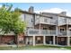 View of townhome featuring a multi-level balcony and brick facade, adding architectural interest at 9403 Southern Hills Cir, Lone Tree, CO 80124