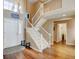 Welcoming foyer featuring hardwood floors, grand staircase, and ample natural light at 9403 Southern Hills Cir, Lone Tree, CO 80124