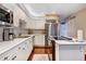 Well-lit kitchen with stainless steel appliances, light countertops, and wooden floors at 9403 Southern Hills Cir, Lone Tree, CO 80124