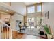 Bright living room features a soaring ceiling, large windows, and a stone fireplace at 9403 Southern Hills Cir, Lone Tree, CO 80124