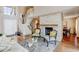 Living room with a fireplace, wooden floors, stairs to the second floor and lots of natural light at 9403 Southern Hills Cir, Lone Tree, CO 80124