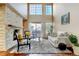 Spacious living room with a fireplace, two-story ceiling and lots of natural light and hardwood floors at 9403 Southern Hills Cir, Lone Tree, CO 80124