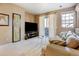 Comfortable living room featuring a neutral color palette, lots of natural light, and access to a balcony at 9403 Southern Hills Cir, Lone Tree, CO 80124