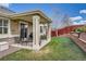 Outdoor patio area with seating, complemented by a green lawn and beautifully landscaped garden beds at 23808 E Bellewood Dr, Aurora, CO 80016