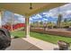 Covered patio overlooking a well-maintained backyard with a lush lawn and attractive landscaping at 23808 E Bellewood Dr, Aurora, CO 80016