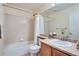 Clean bathroom showcasing a shower-tub combo, white tile, and a bright, functional vanity area at 23808 E Bellewood Dr, Aurora, CO 80016