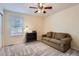 Cozy bedroom with neutral carpet, ceiling fan, and a comfortable brown sofa for relaxing at 23808 E Bellewood Dr, Aurora, CO 80016