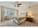 Relaxing bedroom with a neutral color scheme, lots of light from the bay window, and plush carpeting at 23808 E Bellewood Dr, Aurora, CO 80016