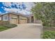 Charming brick home featuring a two-car garage, well-maintained lawn, and mature trees at 23808 E Bellewood Dr, Aurora, CO 80016