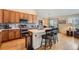 Kitchen with stainless steel appliances, island, and tiled backsplash at 23808 E Bellewood Dr, Aurora, CO 80016