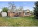 Backyard features a patio seating area, well-maintained lawn, brickwork, and a storage shed at 1100 Pontiac St, Denver, CO 80220