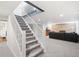 Finished basement with carpeted stairs, stone fireplace, and cozy seating area at 1100 Pontiac St, Denver, CO 80220