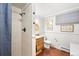 This bathroom features a shower, single sink, and toilet with hardwood floors at 1100 Pontiac St, Denver, CO 80220