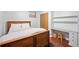This bedroom features a wood frame bed, hardwood floors, desk and chair for great natural light at 1100 Pontiac St, Denver, CO 80220