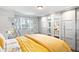 Bright bedroom with large sliding mirrored closet doors and large window with patterned curtains at 1100 Pontiac St, Denver, CO 80220