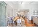 Bright dining room with a wooden table, chandelier, and a comfortable bench seat at 1100 Pontiac St, Denver, CO 80220