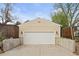 This garage features an white door with an elevated concrete driveway for easy access at 1100 Pontiac St, Denver, CO 80220