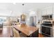 Kitchen with stainless steel appliances, a center island, and hardwood flooring at 1100 Pontiac St, Denver, CO 80220