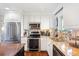 Bright kitchen featuring stainless steel appliances and a granite countertop at 1100 Pontiac St, Denver, CO 80220