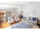Spacious living room flows into dining area with hardwood floors, neutral decor, and ample natural light at 1100 Pontiac St, Denver, CO 80220