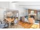 Open-concept living room with a fireplace, hardwood floors, and dining area with lots of natural light at 1100 Pontiac St, Denver, CO 80220