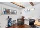 Bright office space with hardwood floors, exposed wood beams, and a cozy chair with a golf bag at 1100 Pontiac St, Denver, CO 80220