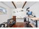 Bright office space with hardwood floors, exposed wood beams, and modern desk setup at 1100 Pontiac St, Denver, CO 80220