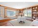 Cozy room with hardwood floors, large windows, and custom built-in shelving at 1100 Pontiac St, Denver, CO 80220