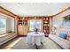 Bright room with hardwood floors, large windows, and custom built-in shelving at 1100 Pontiac St, Denver, CO 80220
