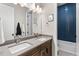 Bathroom featuring double sink vanity and tub with modern blue tiling at 741 Green Mountain Dr, Erie, CO 80516
