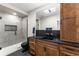 This bathroom features a glass shower, modern fixtures, and sleek black countertops at 741 Green Mountain Dr, Erie, CO 80516