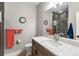 The bathroom has modern fixtures, a vanity with marble counter and a large mirror at 741 Green Mountain Dr, Erie, CO 80516