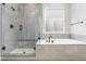 Contemporary bathroom featuring a soaking tub and a frameless glass shower at 741 Green Mountain Dr, Erie, CO 80516