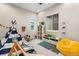 Bright bedroom with teepee, toy storage, rug, and natural light from two windows at 741 Green Mountain Dr, Erie, CO 80516