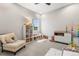 Neutral room featuring a comfortable chair, changing table and toy storage at 741 Green Mountain Dr, Erie, CO 80516