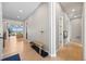 Hallway with access to the living room featuring luxury vinyl floors and modern decor at 741 Green Mountain Dr, Erie, CO 80516