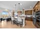 Elegant kitchen with dark wood cabinets, stainless steel appliances, and counter seating at 741 Green Mountain Dr, Erie, CO 80516