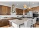 Gourmet kitchen featuring a center island with bar seating and stainless steel appliances at 741 Green Mountain Dr, Erie, CO 80516