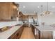 Modern kitchen with custom cabinets, stainless steel appliances, marble countertops, and hardwood floors at 741 Green Mountain Dr, Erie, CO 80516