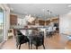 Modern kitchen featuring dark wood cabinets, stainless steel appliances, and a large center island with seating at 741 Green Mountain Dr, Erie, CO 80516
