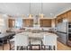 Beautiful kitchen with dark wood cabinets, stainless steel appliances, and marble countertops at 741 Green Mountain Dr, Erie, CO 80516